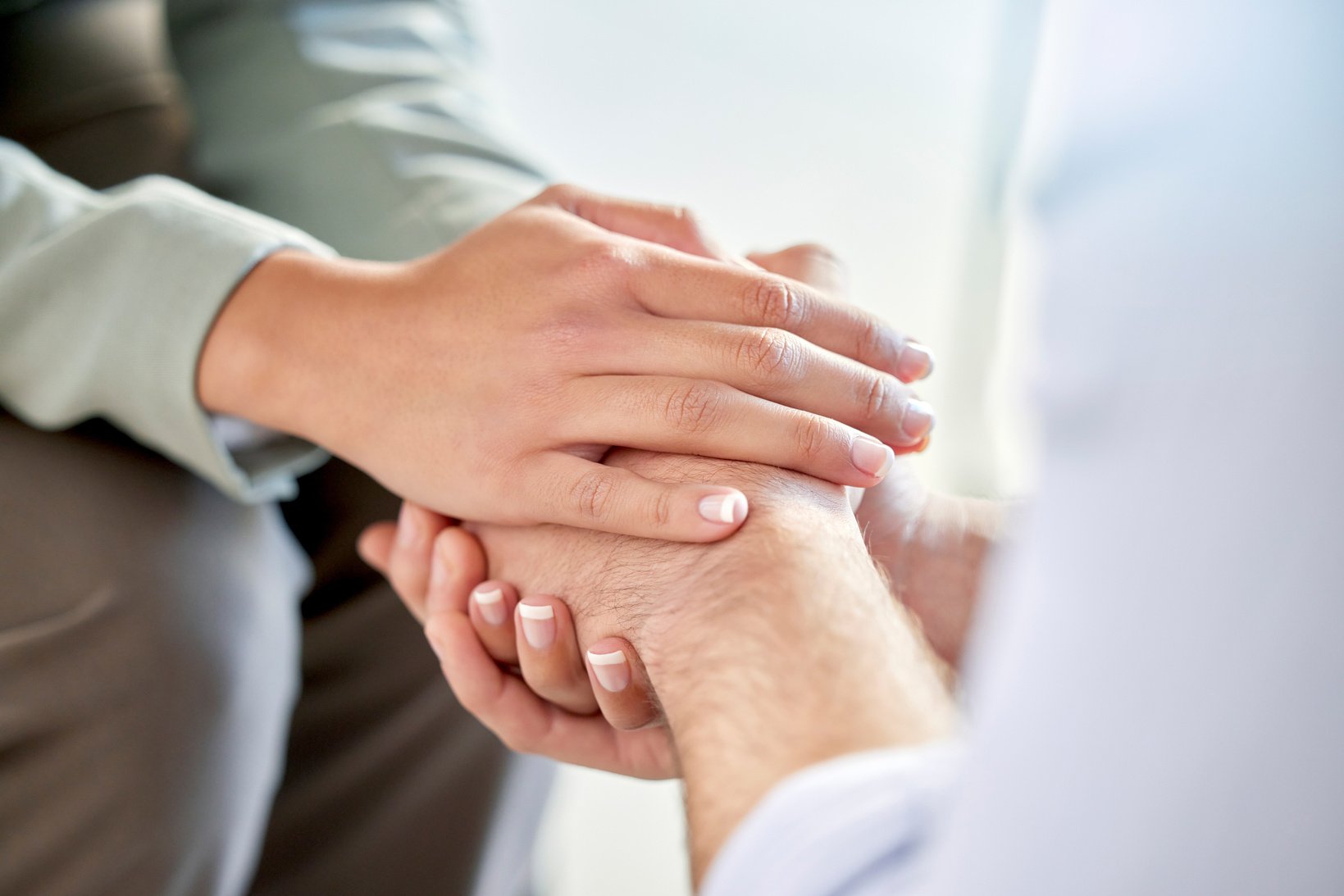 holding hands, support and community hand gesture to show care, love and counseling. Trust, help and healing help hands sign of couple of friends together for gratitude, sorry or mental health advice